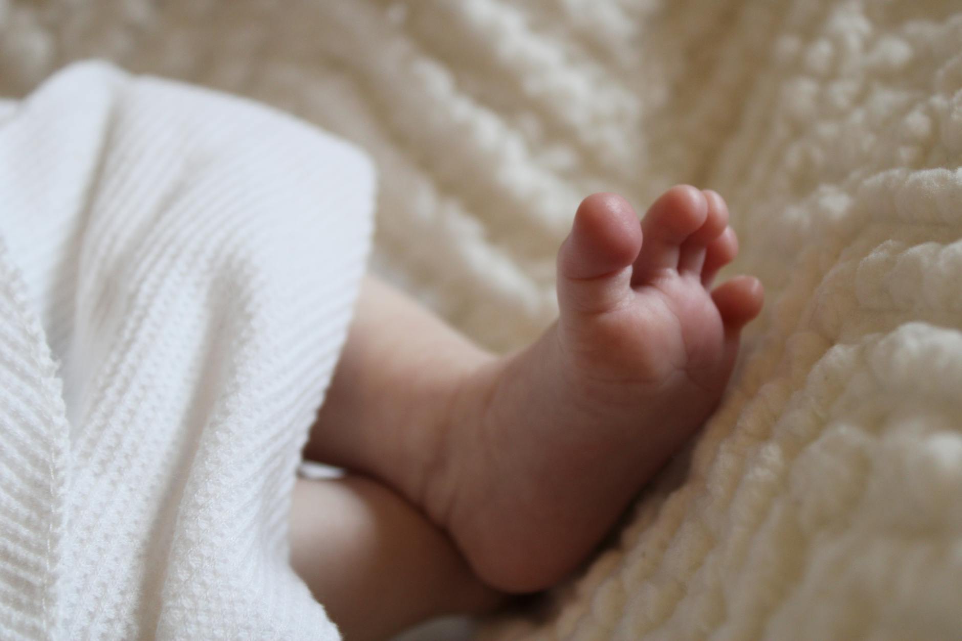 close up of baby feet in soft blanket